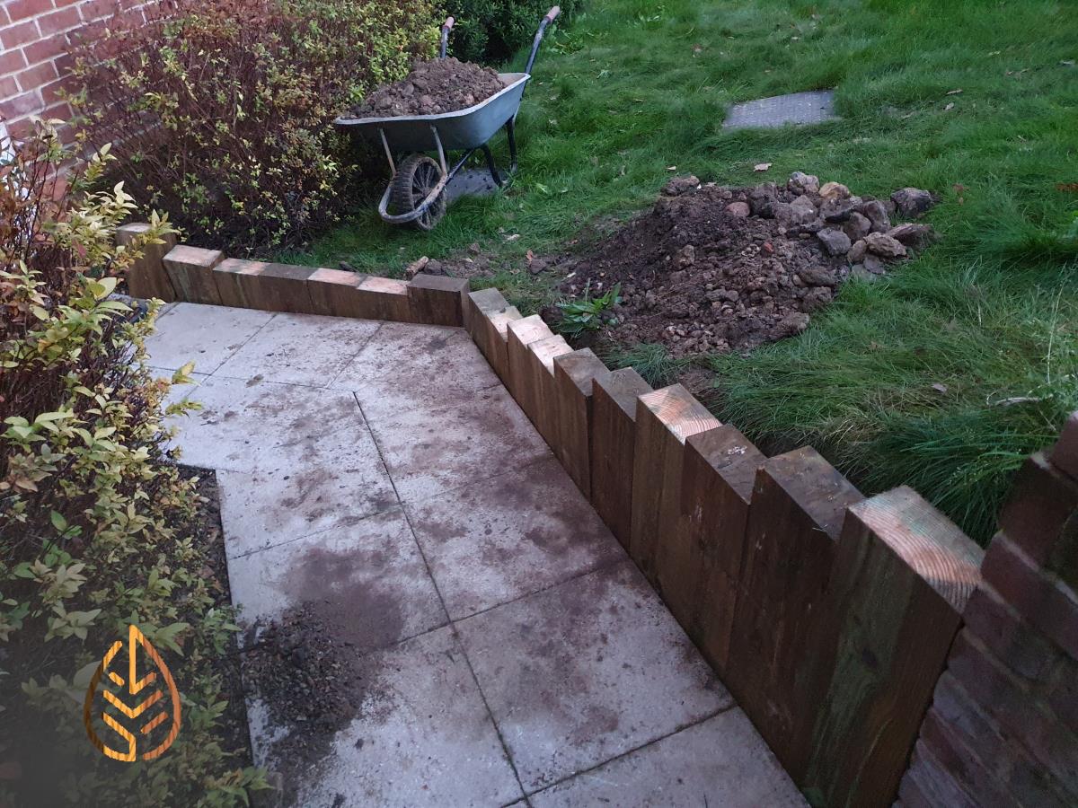 Installation of a new sleeper wall alongside a footpath.