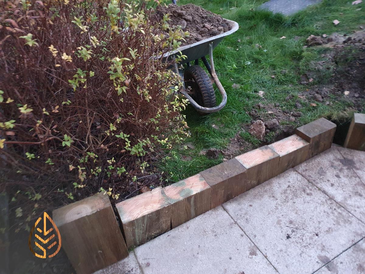 Installation of a new sleeper wall alongside a footpath.