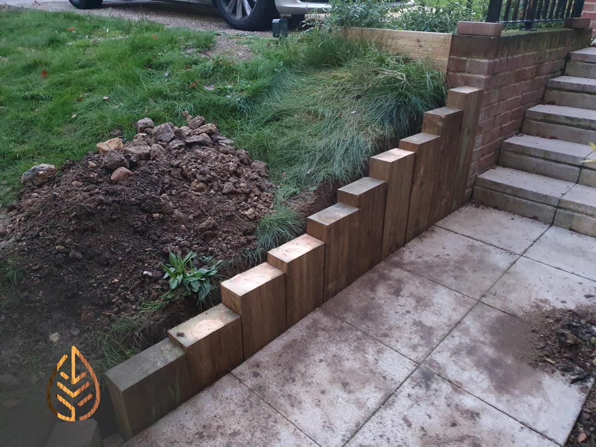 Installation of a new sleeper wall alongside a footpath.