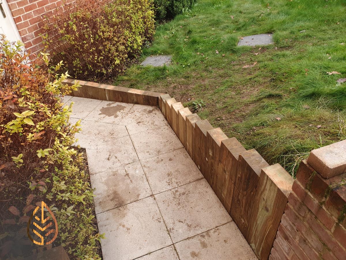 Installation of a new sleeper wall alongside a footpath.