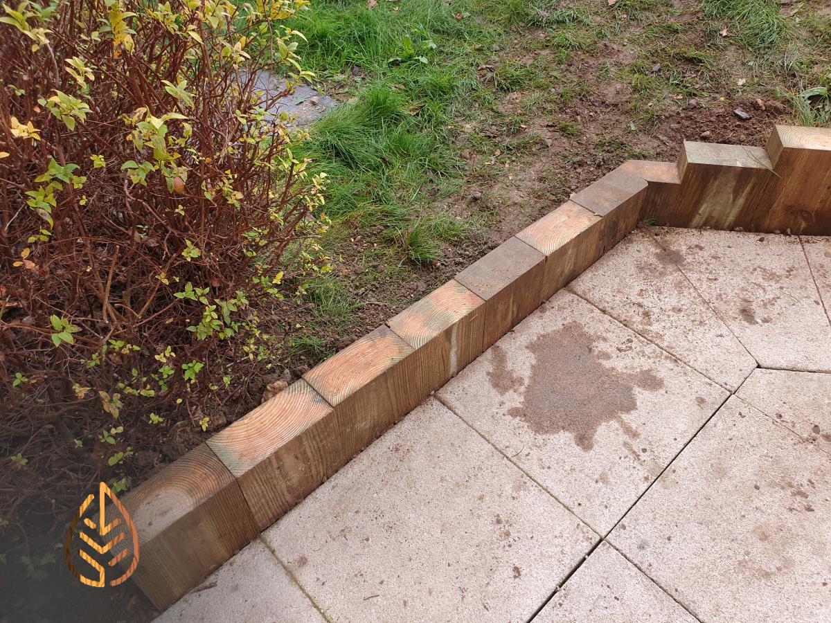 Installation of a new sleeper wall alongside a footpath.