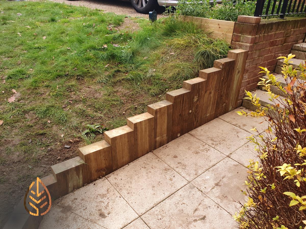 Installation of a new sleeper wall alongside a footpath.